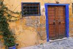 Door to blue and yellow wall, Chania, Crete.