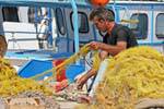 Fisherman cleaning his nets, Iraklio (Heraklion), Crete.
