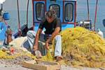 Hammering shellfish caught in the net, Iraklio port (Heraklion), Crete.
