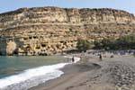 The beach in arch and the protected site of the tomb caves of Matala, Crete.