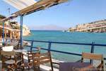 The entrance to the natural harbor from the terrace of a tavern, Matala, Crete.