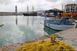 Rethymnon, fishing net and tourist boat in the old harbor, Crete.