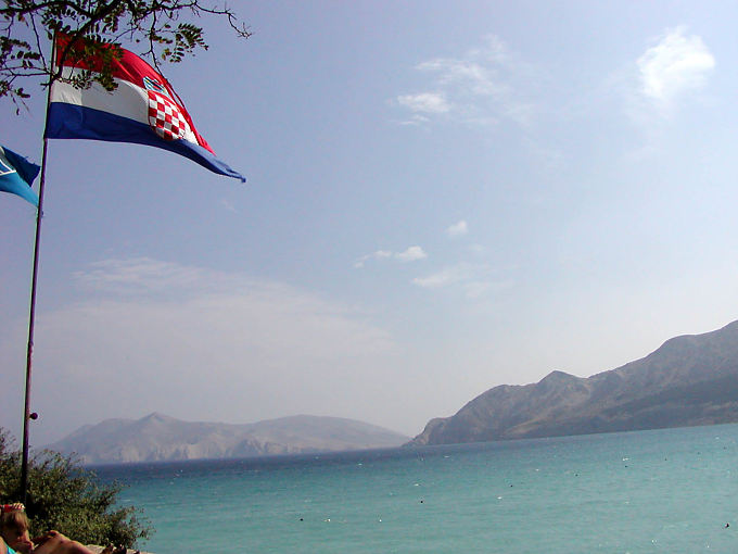 Floating Croatian flag in front of the Adriatic, Krk, Croatia
