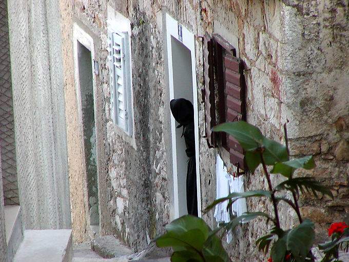 The old Croatian black on his doorstep, Sibenik, Croatia