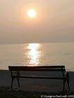 Bench at the water's edge at sunset, Krk, Croatia.