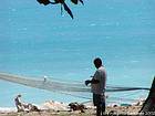 Fishing net darning along the Caribbean Sea, Dominican Rep..