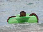 Kid in a green lagoon buoy, Boca Chica, Dominican Rep..