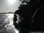 Against the light, motorcycle passing on the waves, Boca Chica, Dominican Rep..