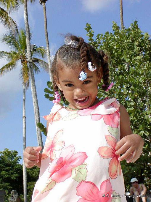 Laugh at the little Dominican wearing a floral dress, Bayahibe, Dominican Rep.
