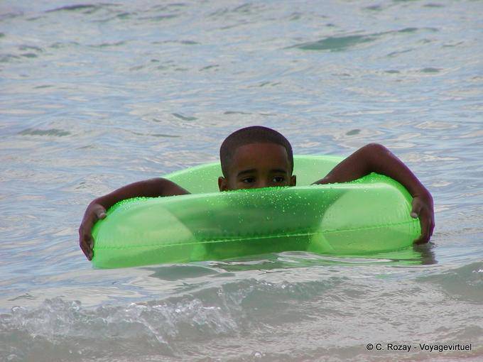 Kid in a green lagoon buoy, Boca Chica, Dominican Rep.