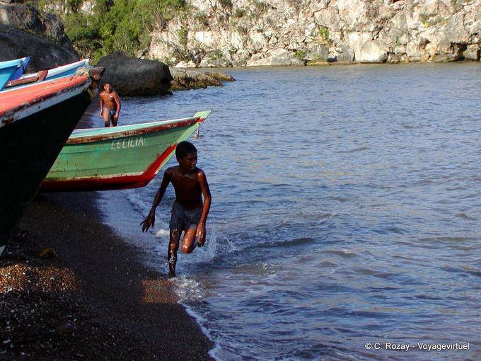 Kid running on the black sand, Boca de Yuma, Dominican Rep.