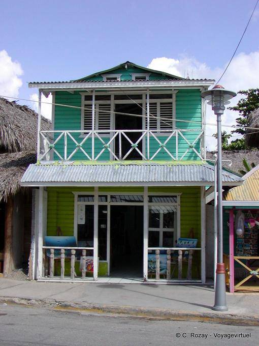 Balcony wooden house painted in shades of green, Boca de Yuma, Dominican Rep.