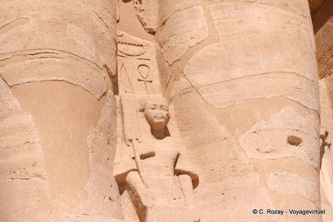 Prince Ramses (son of Isis Nofret) between the legs of the pharaoh, Abu Simbel - Egypt