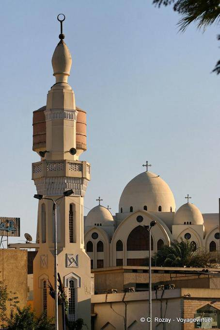 The minaret of the mosque before the domes of the Church of St. George, Aswan - Egypt