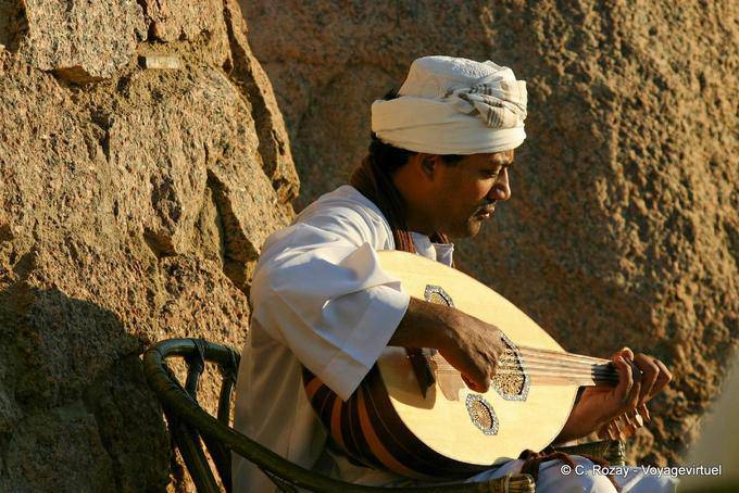 Musician playing the 3ood, oriental lute before the Old Cataract Aswan - Egypt