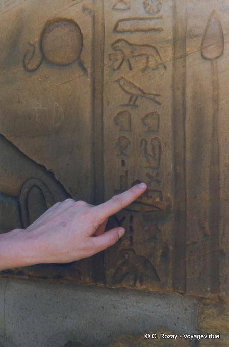 Finger on hieroglyphics, temple of Edfu - Egypt