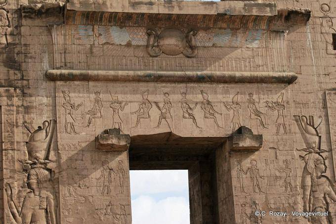 Above the portal of the forecourt with Horus depicted as a winged sun temple of Edfu - Egypt