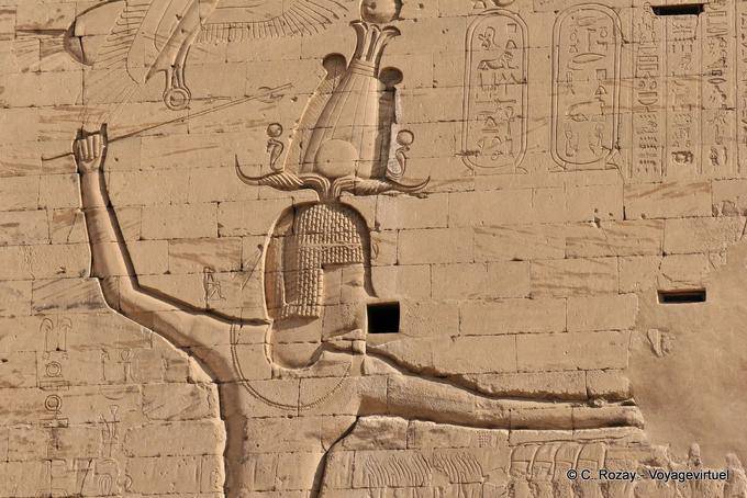 Pharaoh Ptolemy XII into enemies by the hair, relief pylon, Edfu temple - Egypt