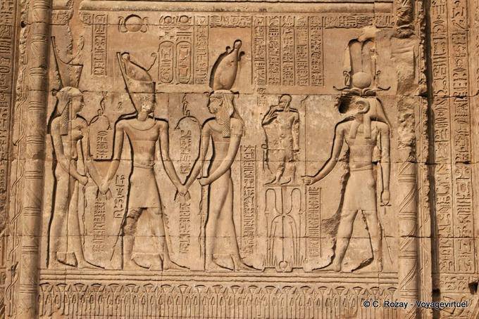 Gods, goddesses and pharaoh holding hands, facade, Esna Temple - Egypt