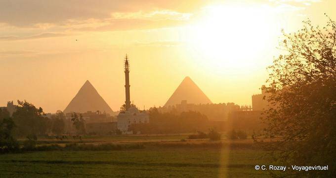 The minaret between the pyramids at sunset, Cairo - Egypt
