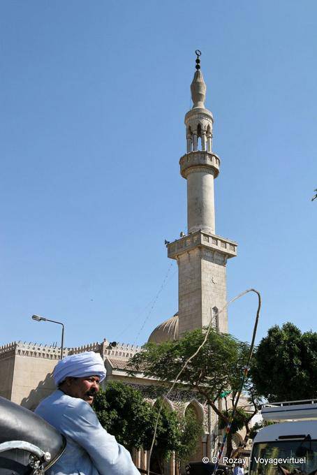 Horse carriage driver and minaret in Luxor - Egypt