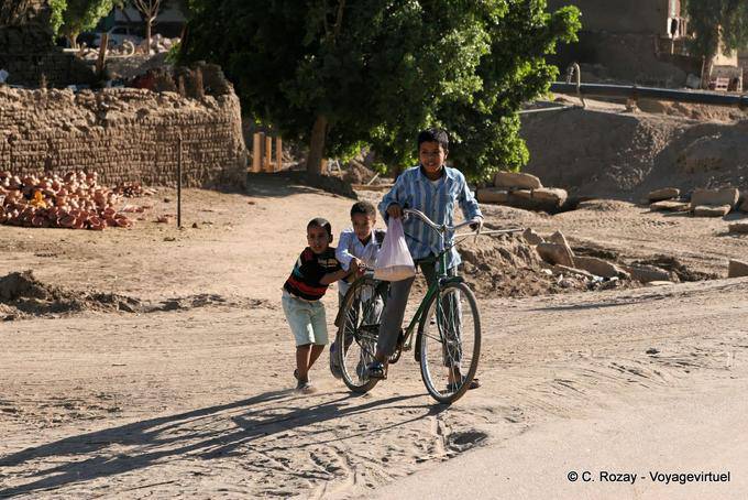 Three children with a bike, Luxor - Egypt