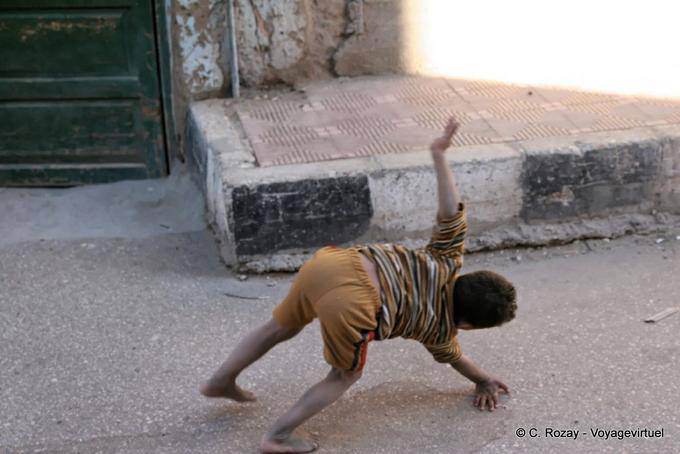 Young acrobat in the street, Luxor - Egypt