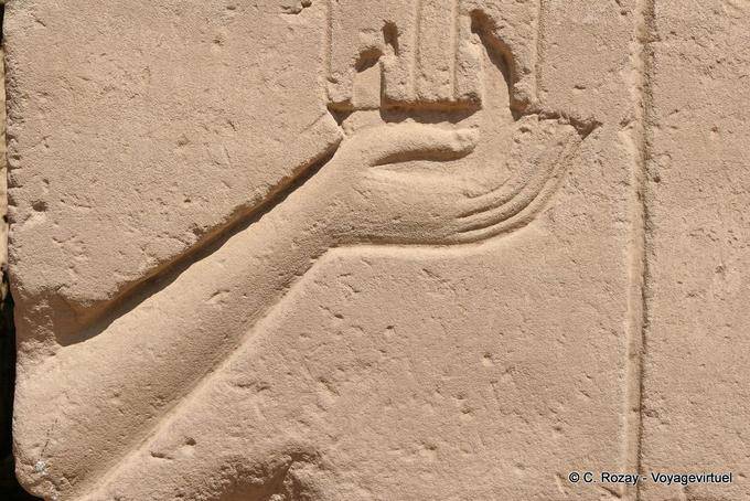 Hand holding an offering relief fragment, Karnak Temple - Egypt