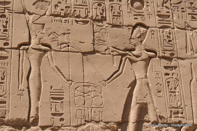 Relief of offering to the god of the king, surrounded by cartridges with hieroglyphics, Karnak - Egypt