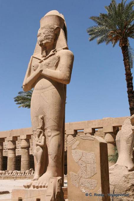 High statue of Ramses II, with his daughter and royal bride on her feet, Karnak - Egypt