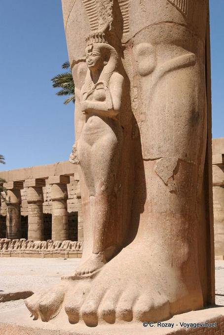 The Princess Bentata between the legs of stone colossus, Karnak - Egypt