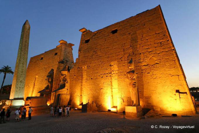 The pylon of Ramses II, and staues colossal obelisk view night lighting, Luxor - Egypt