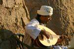 Musician playing the 3ood, oriental lute before the Old Cataract Aswan, Egypt.