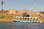 Tourist boat in front of the Temple of Khnum, Abu Elephantine, Aswan, Egypt.