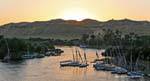 Sunset on the Nile arms and feluccas moored, Aswan, Egypt.