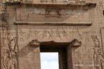 Above the portal of the forecourt with Horus depicted as a winged sun temple of Edfu, Egypt.