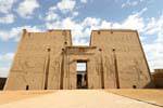 Edfu, the imposing facade of the tower guarded by two statues of Horus at the entrance, Egypt.