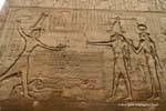 Relief of the god Khnum before Ptolemy into his enemies by the hair, Esna Temple, Egypt.