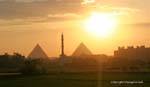 Fabulous sunset over the pyramids flanking the minaret of a mosque, Cairo, Egypt.