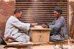Domino players on cardboard on a street, Luxor, Egypt.