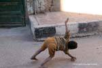 Young acrobat in the street, Luxor, Egypt.