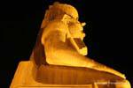At the foot of Rameses II colossus sitting, night view, Luxor Temple, Egypt.