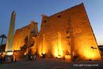 The pylon of Ramses II, and staues colossal obelisk view night lighting, Luxor, Egypt.