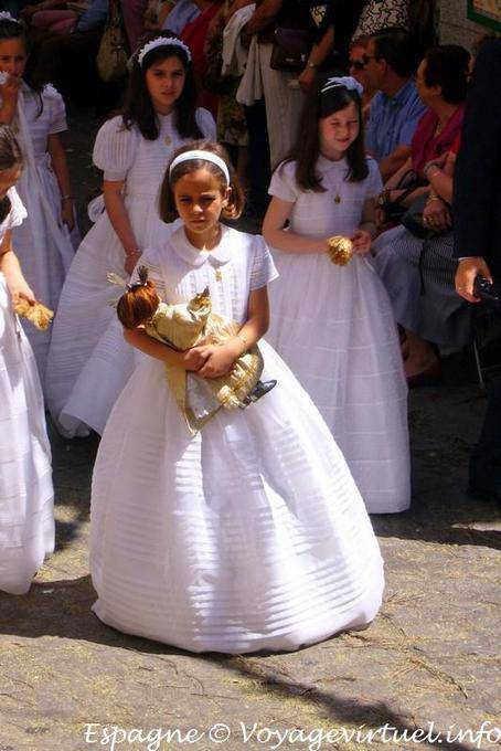 Girl in white dress with a doll procession in Toledo - Spain