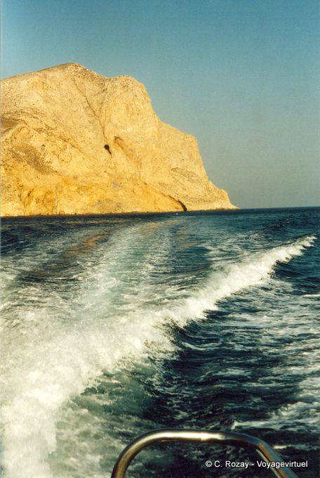 Rock rising from the sea in the wake of the boat, Anafi - Greece