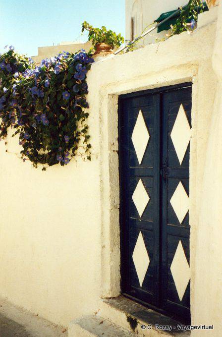 Blue and white door and morning glories morning glory, Oia, Santorini - Greece