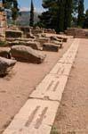 Blocks foot on stage, Delphi, Greece.