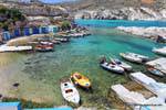 Mandrakia, overlooking the harbor and boathouses in the rock, Milos, Greece.