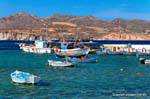 Milos, Pollonia, fishing boats moored opposite Kimolos, Greece.