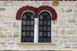 Stone wall and window decorations, Pinakates, Pelion, Greece.